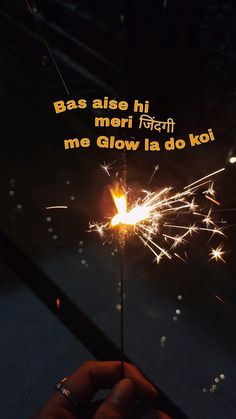 someone holding a sparkler in their hand with the caption'bas aielo hi mori me glow la do koi '