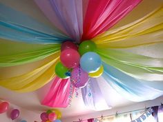 the ceiling is decorated with balloons and streamers