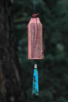 a bird feeder hanging from the side of a tree