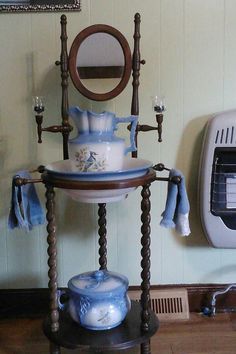 a blue and white vase sitting on top of a wooden stand next to a toaster oven