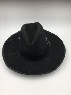 This men's Vintage Hat is a true masterpiece of Bavarian design. The alpine-inspired wide brim, coupled with the black felt material, gives this hat a timeless look that is perfect for any occasion. Circa 1880, this piece is not only stylish but also full of history and character.  Men's hunting hat circa late 1880.  This hunting hat was worn in the alpine areas of the Austro-Hungarian empire. Black wool felted hat with a wide brim edged in leather, deep crease in the crown, and trimmed black ve Western Wool Top Hat, Black High Crown Hat For Country Events, Black Wool Hat Band For Rodeo, Black Wool Hat For Rodeo, Black Wool Rodeo Hat, Black Western Top Hat For Outdoor, Black Wool Felt Hat For Rodeo, Western Black Brimmed Felt Hat, Black Brimmed Western Felt Hat