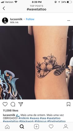 a woman's arm with a flower tattoo on the left side of her arm