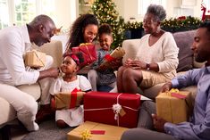 a group of people sitting around each other with presents