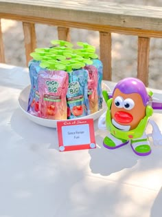 a table topped with toys and snacks on top of it