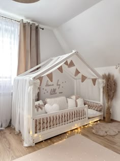 a baby's room with a white crib and lights