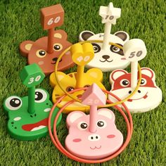 several toy animals sitting in the grass on top of each other with numbers and faces