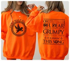 two women wearing orange sweatshirts with the words oh dear grumpy on them