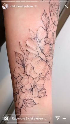 a tattoo with flowers on the arm