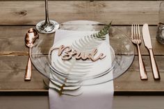 there is a plate with the word bride on it next to silverware and utensils