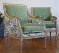 two green chairs sitting on top of a hard wood floor next to a potted plant