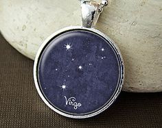 a necklace with the word genni written on it and stars in the sky around it