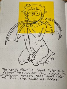 an open notebook with a drawing of a cartoon character on the cover and some words written in black ink