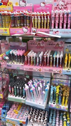 many different kinds of toothbrushes are on display in a toy store with hello kitty products