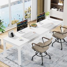 an office desk with two computer monitors and chairs in front of large windows overlooking the water