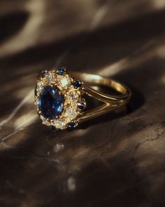 a gold ring with blue and white stones