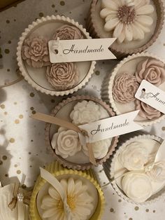 several cupcakes with flowers and labels on them