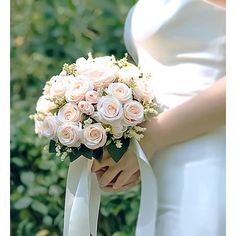 Crafted with stunning silk roses, lush artificial leaves, elegant ribbons, and delicate pearls, this bouquet exudes timeless charm. Unkoma | Unkoma Wedding s for Bride Bridesmaid Champagne Artificial Roses Fabric in Bouquet | 13.78" H X 7.87" W X 7.87" D | Wayfair Wedding Bouquets For Bride, Bridal Bouquets White, Civil Wedding Ideas, Bridesmaid Champagne, Elegant Wedding Bouquets, Artificial Leaves, Champagne Bridesmaid, White Bridal Bouquet, Artificial Leaf