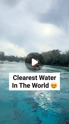 the water is clear and blue with some clouds in the sky above it, as well as text that reads clearest water in the world