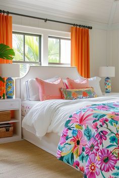 a bedroom with bright orange curtains and floral bedding in front of a large window