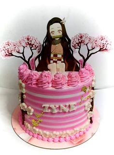 a pink cake decorated with an image of a woman sitting on top of the cake