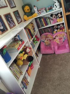 there are two children's chairs in the room with bookshelves and stuffed animals