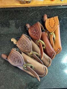 several different types of leather cases on a counter