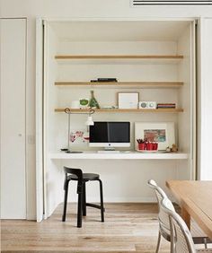 a desk with a computer on top of it