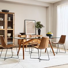 a glass dining table with chairs around it