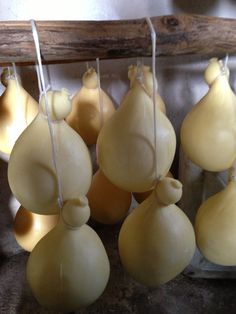 several pieces of food hanging from strings on a rack in a room with wood beams