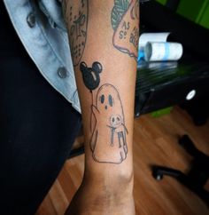 a person with a tattoo on their arm has a ghosty character tattooed on it