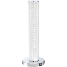 a tall glass vase sitting on top of a metal stand with a light inside it