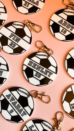 there are many key chains that have soccer balls on them with name tags attached to them