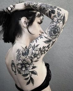 a woman with tattoos on her back and arms