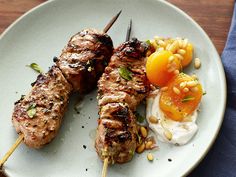 two skewers of meat and vegetables on a plate