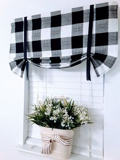 a potted plant sitting on top of a shelf next to a window sill