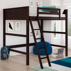 there is a bunk bed with a ladder on the bottom and a blue rug underneath it