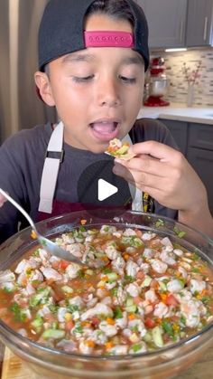 a young boy eating food from a bowl