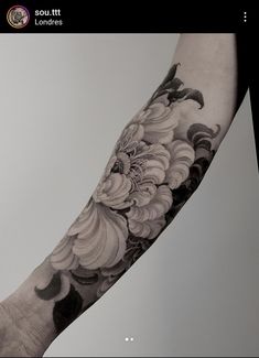 a person with a flower tattoo on their arm