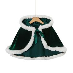 a green cape hanging from a wooden hanger