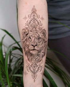 a lion tattoo on the right arm and leg, with an intricate pattern around it