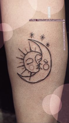 a tattoo on the leg of a person with a sun and moon in it's center