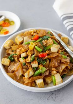 a white bowl filled with stir fry vegetables