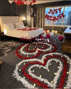 a bedroom decorated in red, white and grey with flowers on the floor for valentine's day