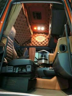 the inside of a vehicle with its door open and seats folded down in front of it