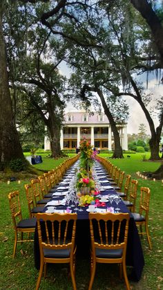 a long table is set up in front of a large house