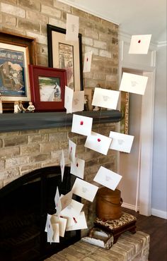 a fireplace with many cards hanging from it