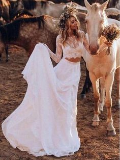 a woman in a wedding dress standing next to a horse