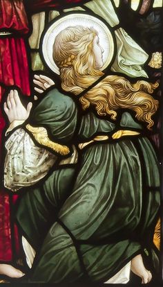 a stained glass window with an image of a woman holding a child in her arms