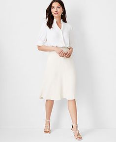 Elevate your wardrobe with the Ann Taylor Petite Flare Skirt in Fluid Crepe, a masterpiece of elegance and comfort. This skirt, designed specifically for petite frames, features a graceful flare that adds a subtle swing to your every step. The ivory whisper color exudes a soft, sophisticated vibe, making it a versatile addition to your collection.

- Size: Petite 0
- Color: Ivory Whisper
- Material: 95% Polyester, 5% Spandex
- Length: 25 inches, hits at knee
- Fit: Tailored fit
- Closure: Hidden Black Womens Suit, Suit Skirts, The Flare, Ann Taylor Petite, Knitted Suit, Elegant Skirt, Petite Women, Casual Chic Style, Office Outfits