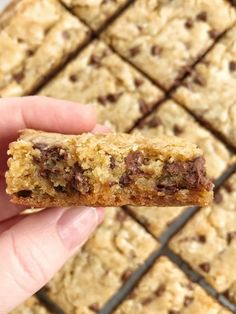 a hand holding a chocolate chip cookie bar